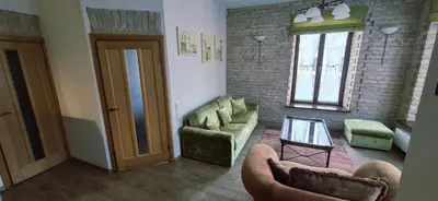 a living room with two couches and a table at Apartamentai Vilnius Užupis in Vilnius