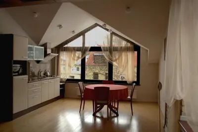 a kitchen with a table and a window in a room at Apartamentai Vilnius Užupis in Vilnius