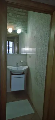 a bathroom with a sink and a mirror at Apartamentai Vilnius Užupis in Vilnius