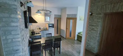 a kitchen and dining room with a table and chairs at Apartamentai Vilnius Užupis in Vilnius
