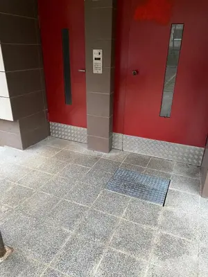 a bathroom with a red wall and a tile floor at Two Bedroom COZY apatment in Vilnius