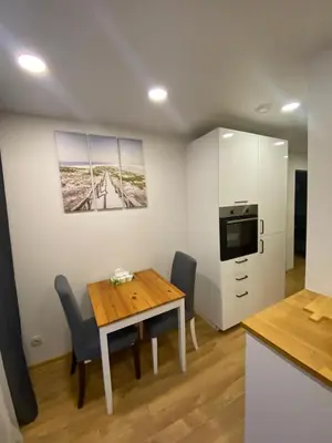 a kitchen and dining room with a table and chairs at Two Bedroom COZY apatment in Vilnius