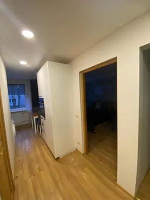 a room with a hallway with a door and a table at Two Bedroom COZY apatment in Vilnius