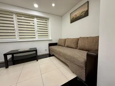 a living room with a couch and a table at Guest house 10 minutes from the city center in VNO