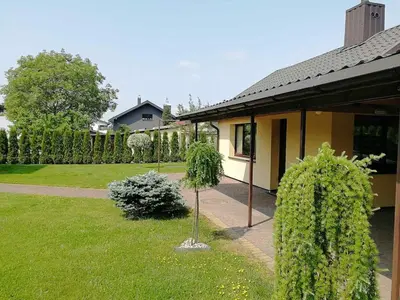 a house with a small tree in the yard at Guest house 10 minutes from the city center in VNO