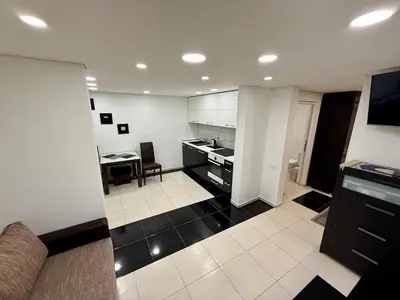 a kitchen with a couch and a table in a room at Guest house 10 minutes from the city center in VNO