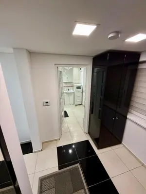 a living room with a black and white tile floor at Guest house 10 minutes from the city center in VNO