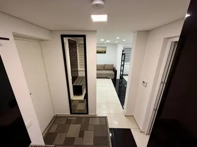 a hallway with a mirror and a living room at Guest house 10 minutes from the city center in VNO