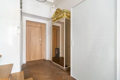 a hallway with a mirror and a door at Old Town Luxury apartment self check inn in Vilnius