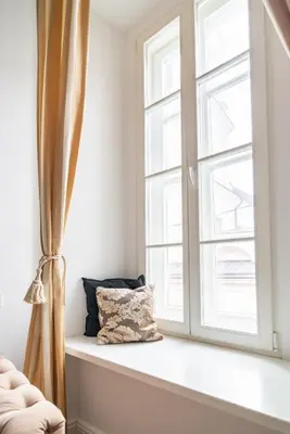 a window seat with a pillow sitting next to it at Old Town Luxury apartment self check inn in Vilnius