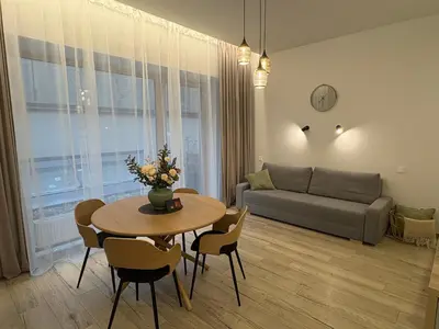 a living room with a table and a couch at Studio 204 Vilnius Old Town in Vilnius