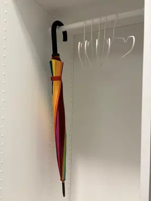 a colorful umbrella hanging in a closet at Studio 204 Vilnius Old Town in Vilnius