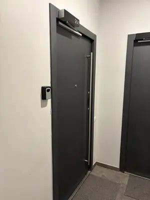 a black elevator door in a white wall at Studio 204 Vilnius Old Town in Vilnius