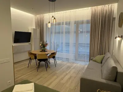 a living room with a couch and a table at Studio 204 Vilnius Old Town in Vilnius