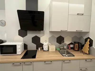 a kitchen counter with a microwave and a sink at Studio 204 Vilnius Old Town in Vilnius