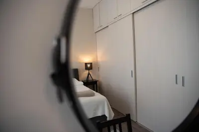 a room with two beds and a mirror at Stylish & Brand New 1 BDR Apartment in Old Town in Vilnius