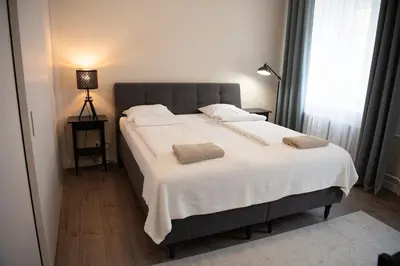 a bedroom with a large bed with two pillows on it at Stylish & Brand New 1 BDR Apartment in Old Town in Vilnius