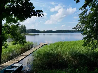 a dock on a lake with two boats on it at Vila Zara in Zarasai