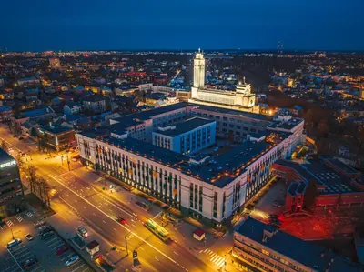 an aerial view of a large building with a clock tower at Rooftop Terrace Loft 15 Minute Walk to Zalgiris Arena in Kaunas