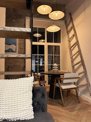 a living room with a loft bed and a table at Rooftop Terrace Loft 15 Minute Walk to Zalgiris Arena in Kaunas