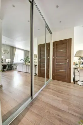 a living room with glass doors and wooden floors at Vilnius Central Apartment Free Parking in Vilnius