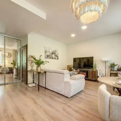 a living room with a couch and a tv at Vilnius Central Apartment Free Parking in Vilnius