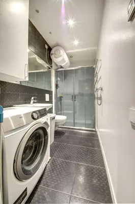 a washing machine in a bathroom with a toilet at Vilnius Central Apartment Free Parking in Vilnius
