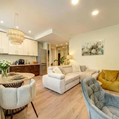a living room with two couches and a table at Vilnius Central Apartment Free Parking in Vilnius