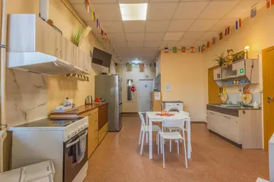 a kitchen with a table and chairs in it at Kaunas Center Hostel - Self-Check In in Kaunas