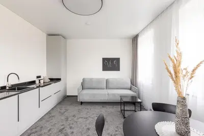a living room with a couch and a table at Varenastay in Varėna