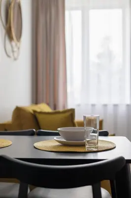 a table with a plate and a glass on it at Varenastay in Varėna