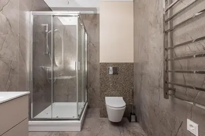 a bathroom with a shower and a toilet at Varenastay in Varėna