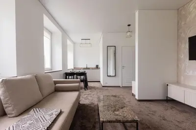 a living room with a couch and a table at Varenastay in Varėna