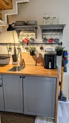 a kitchen with a sink and a counter with pots and pans at Vila Vynuogyne in Paberžė