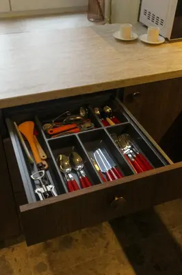 a drawer filled with tools in a kitchen counter at K15 History Apartments in Vilnius