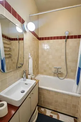 a bathroom with a white tub and a sink at K15 History Apartments in Vilnius
