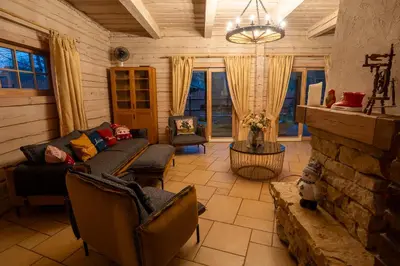 a living room with a couch and a fireplace at Močiutės sodyba in Latežeris
