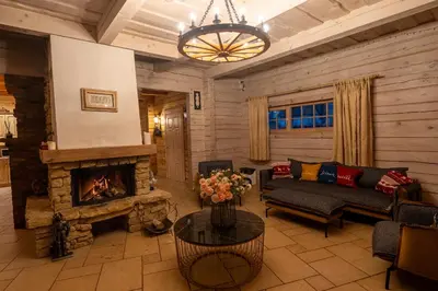 a living room with a couch and a fireplace at Močiutės sodyba in Latežeris