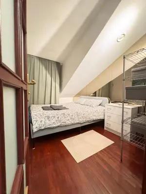 a small bedroom with a bed and a ladder at Old Town Attic Ignoto 16 SELF CHECK IN in Vilnius