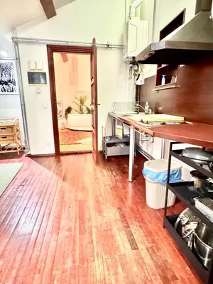 a kitchen with a counter and a wooden floor at Old Town Attic Ignoto 16 SELF CHECK IN in Vilnius