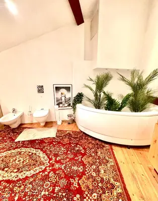 a bathroom with a large tub in the middle of a room at Old Town Attic Ignoto 16 SELF CHECK IN in Vilnius