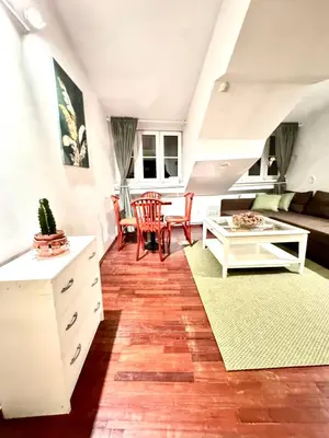 a living room with a couch and a table at Old Town Attic Ignoto 16 SELF CHECK IN in Vilnius