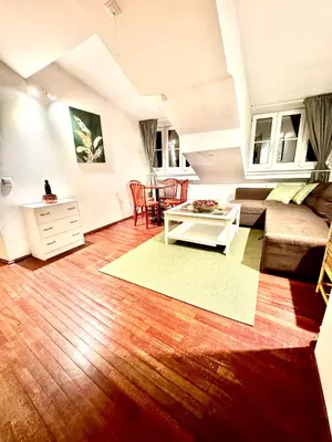 a living room with a couch and a table at Old Town Attic Ignoto 16 SELF CHECK IN in Vilnius
