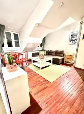 a living room with a couch and a table at Old Town Attic Ignoto 16 SELF CHECK IN in Vilnius