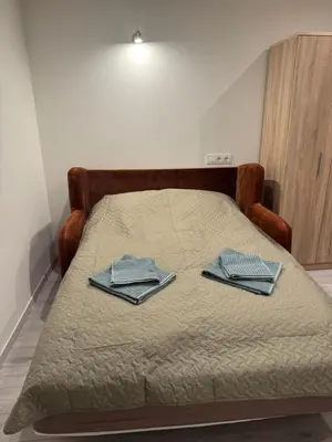 a bed with two towels on top of it at Kasia apartaments in Druskininkai