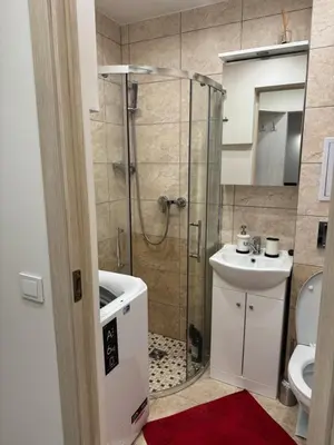 a bathroom with a shower and a toilet and a sink at Kasia apartaments in Druskininkai