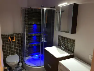 a bathroom with a shower and a toilet and a sink at B-happy Apartments in Vilnius