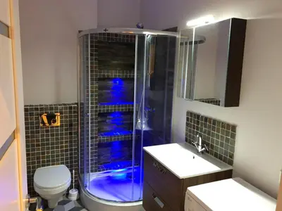 a bathroom with a shower and a toilet and a sink at B-happy Apartments in Vilnius