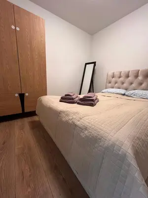 a bedroom with a large bed and a dresser at Mėja stay in Kaunas