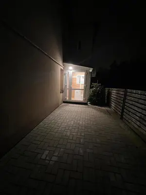 a door to a building with a light at night at Mėja stay in Kaunas